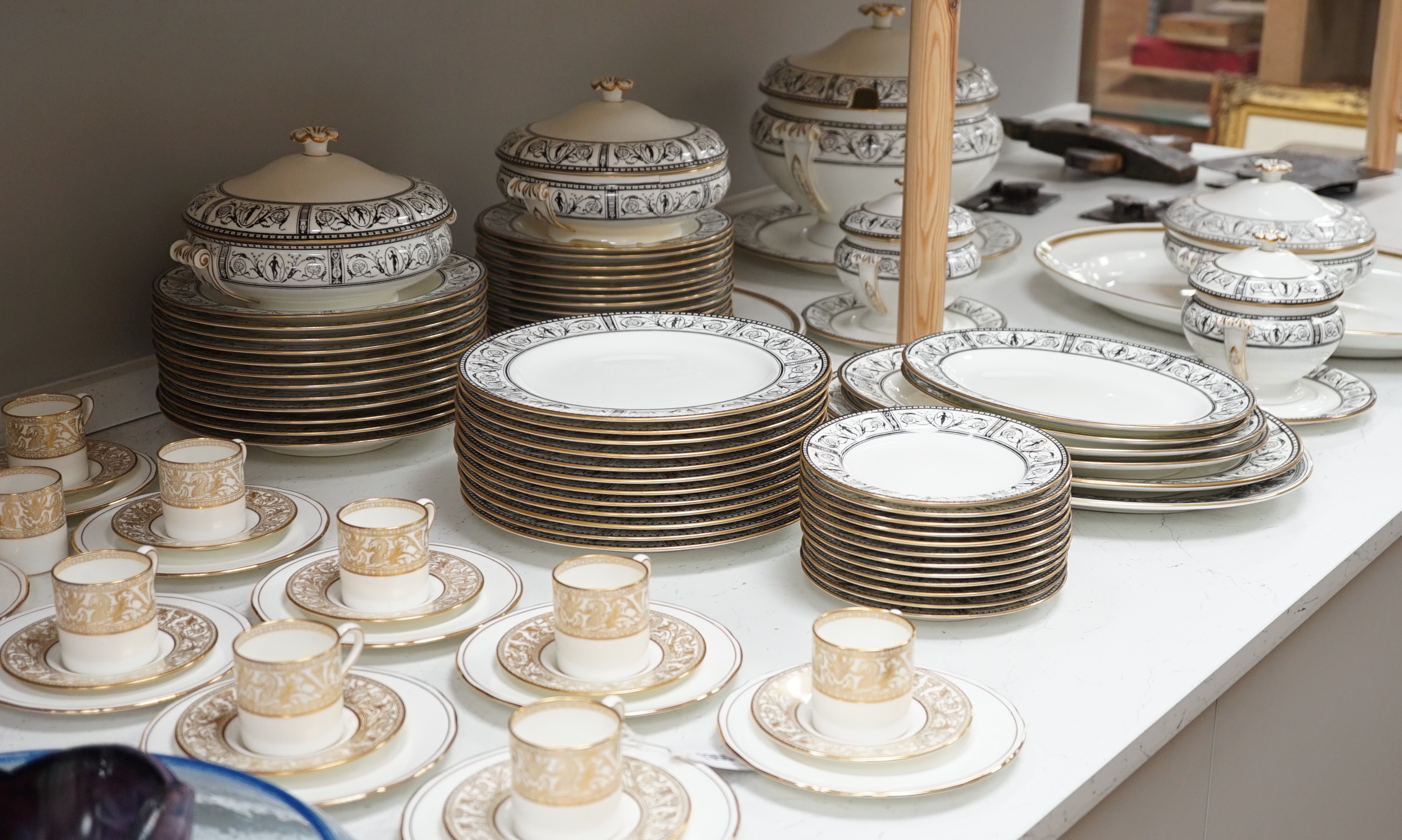 A Victorian Wedgwood part dinner service, with black printed classical borders, together with two Minton meat dishes and a Wedgwood gilt bordered coffee service.